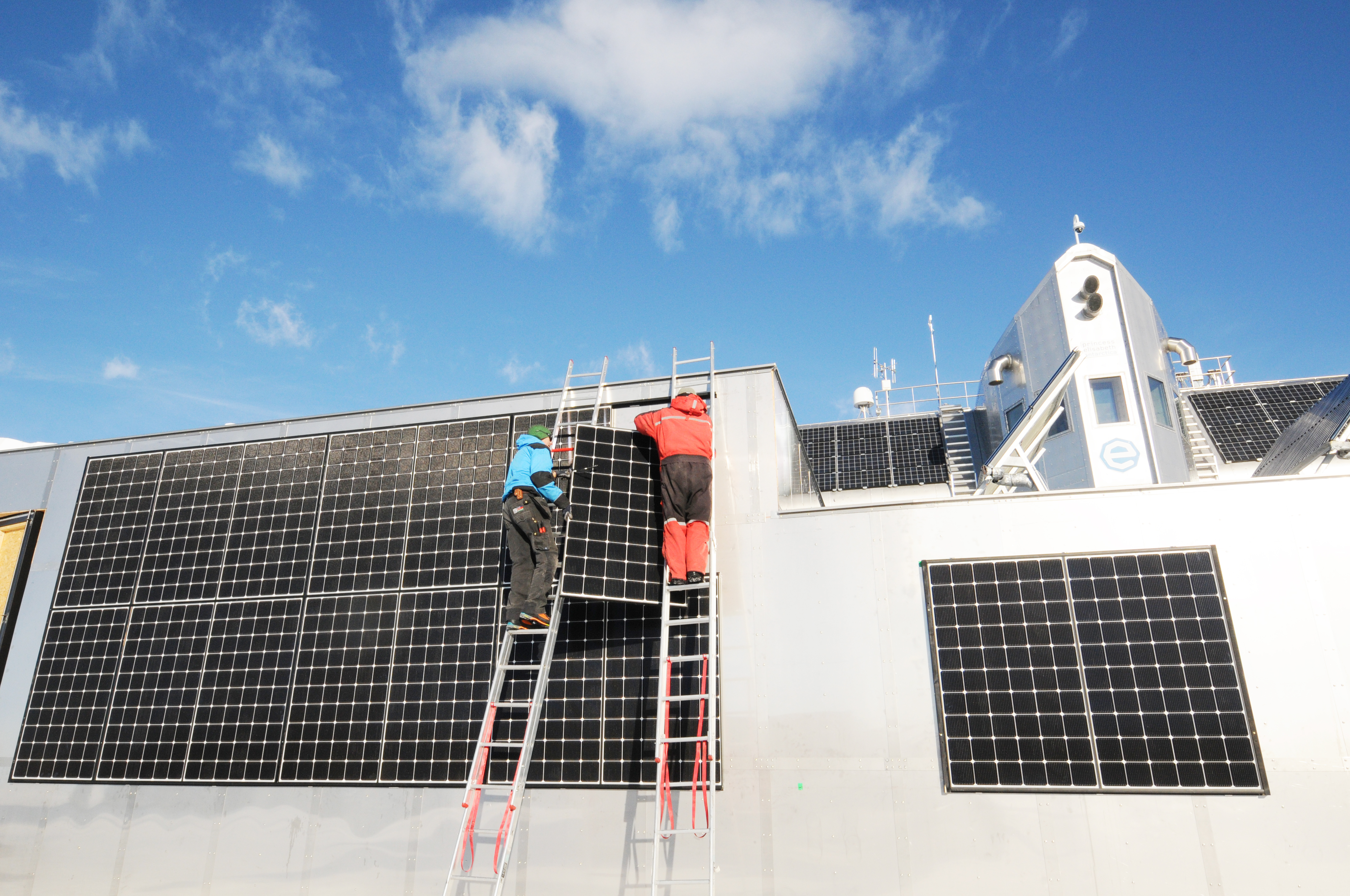 Guus Luppens and Johan Demuylder install new solar panels on PEA's new garage