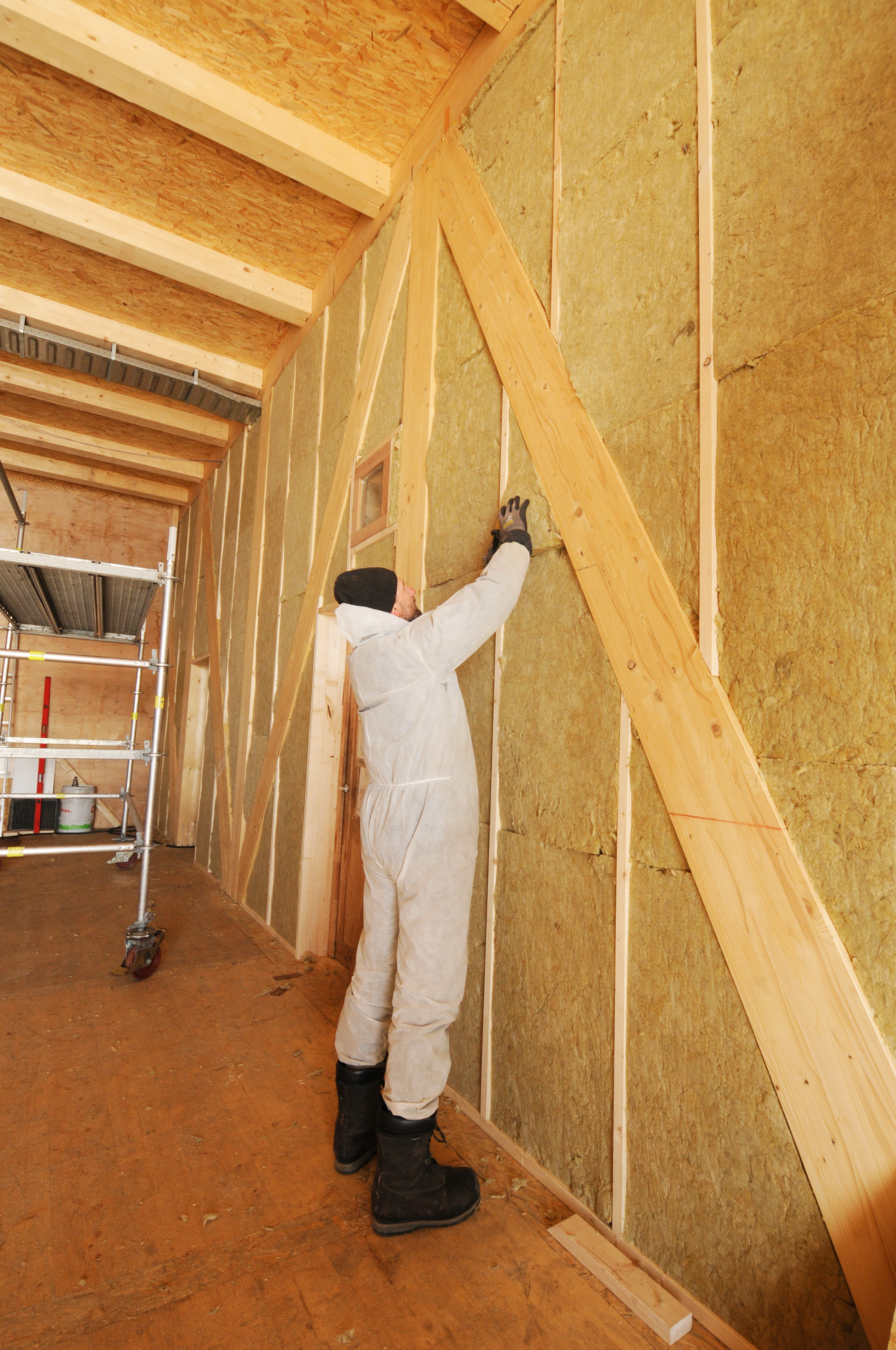 Thomas finalises the insulation in the walls of PEA's new garage