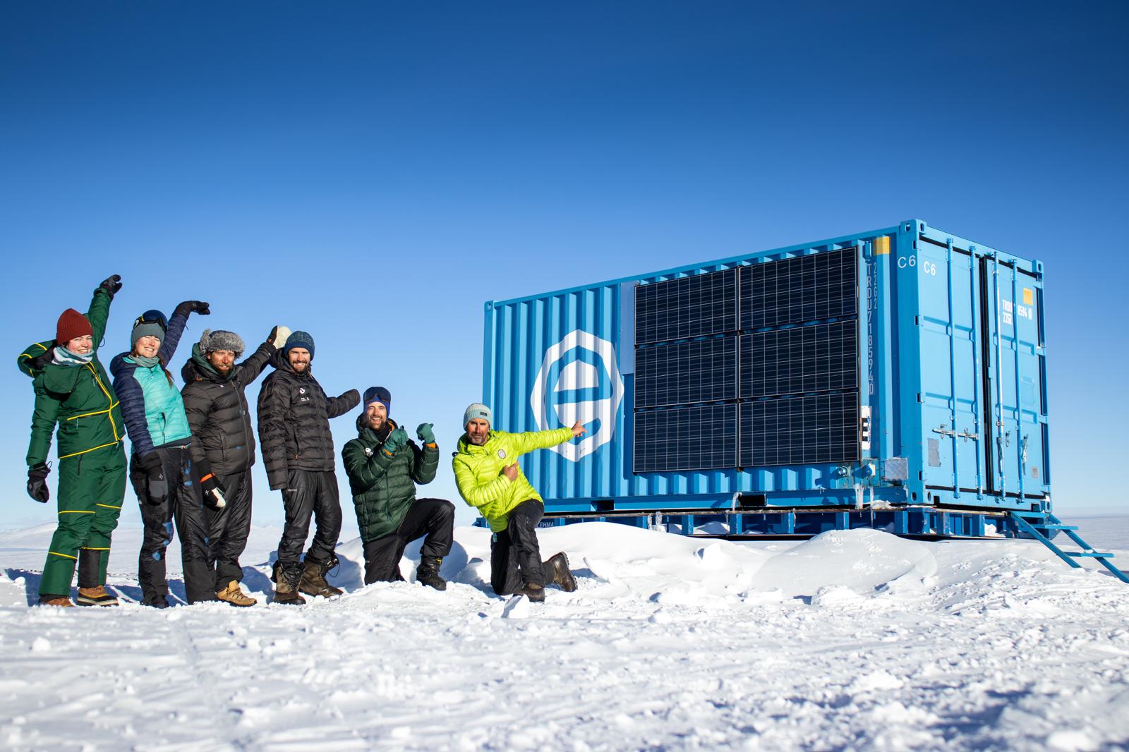 Scientists from the FROID project pose in front of living container