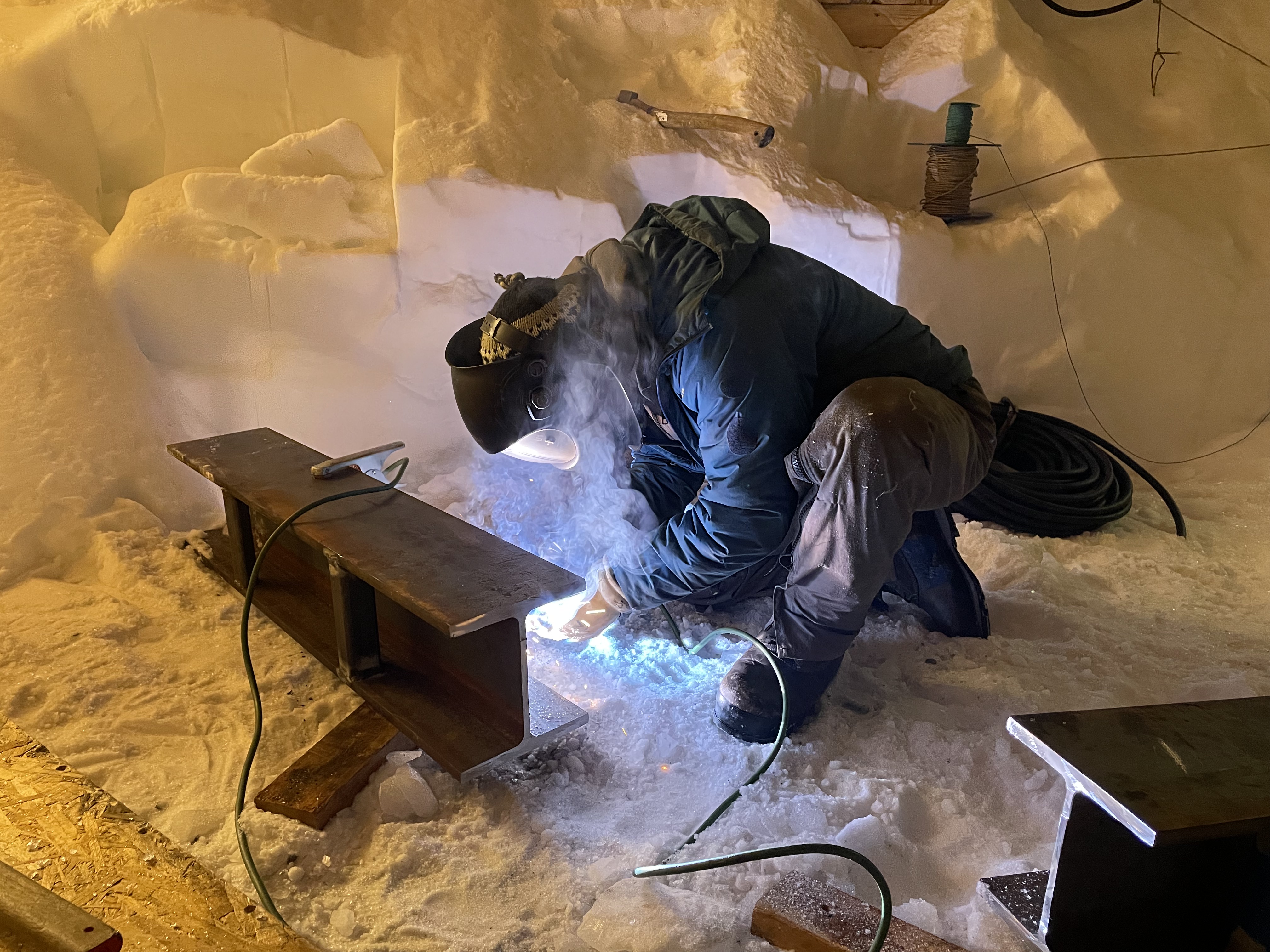 IPF team member welding I-beam support.