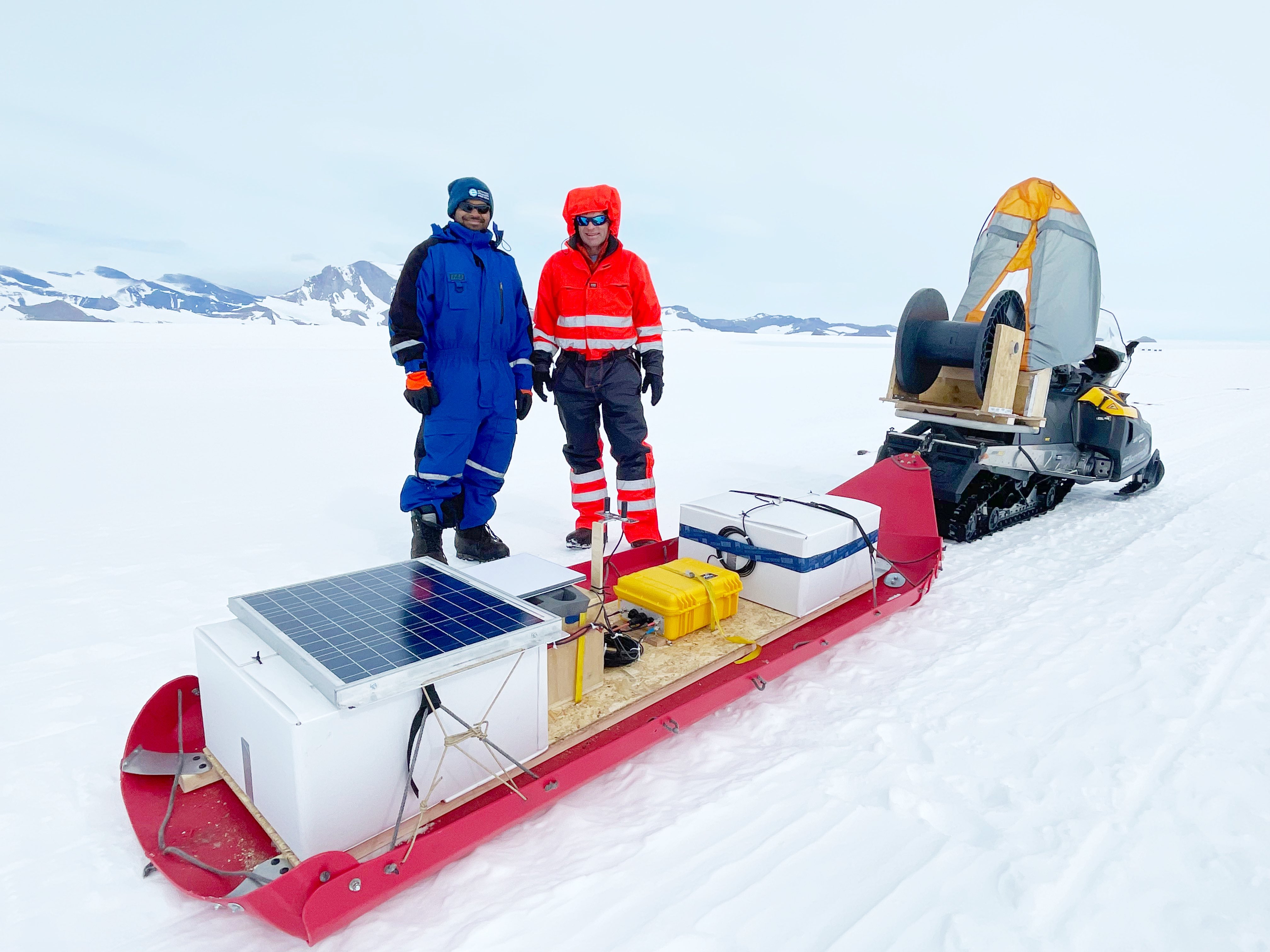 Eric Rignot and Ratnakar Gadi from UC Irvine pose with radar sledge