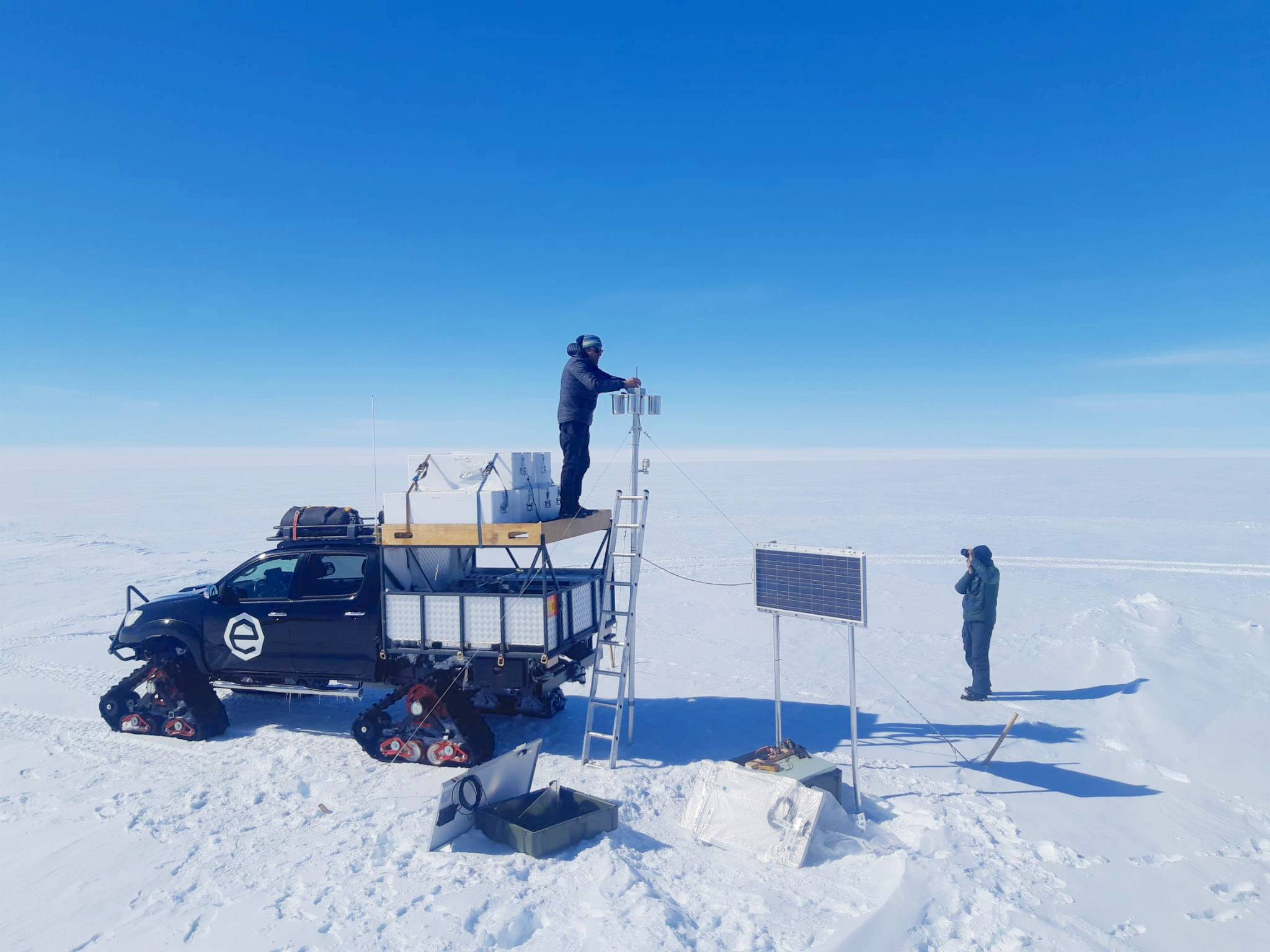 Alain Hubert and Tim Grosrenaud collect samples from the snow sampler for the PASPARTOUT project