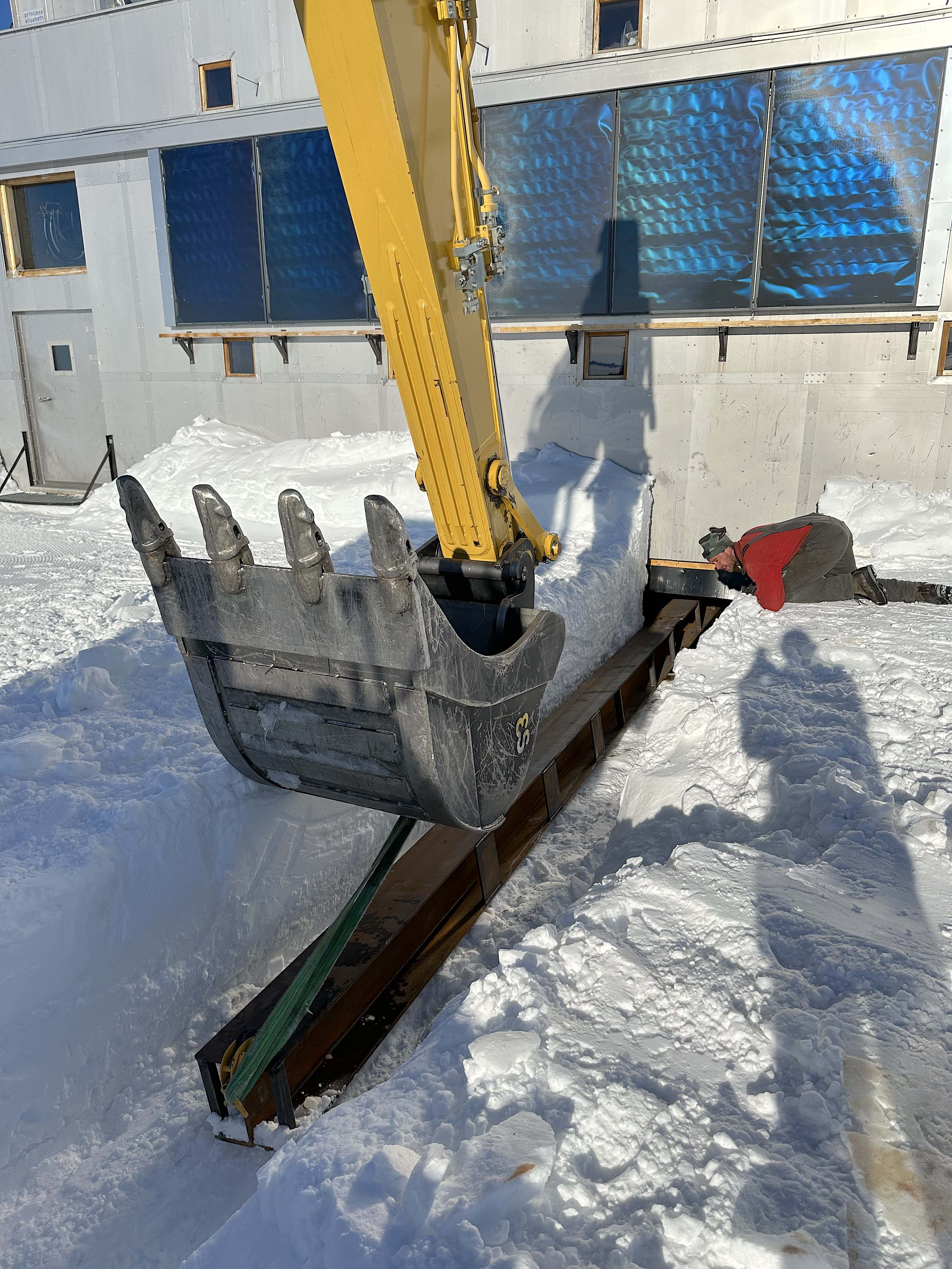 Positioning a metal I-beam beneath the staiton's annex