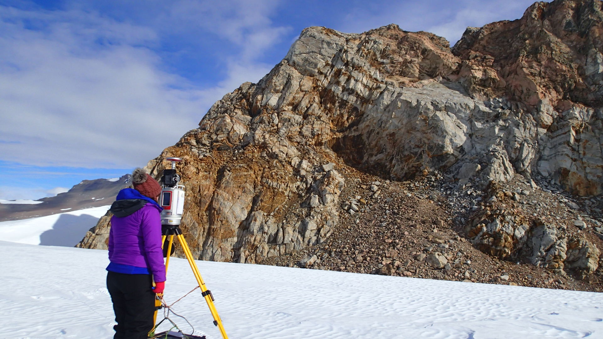 Kate using a terrestrial laser scanner to accurately map the mountains