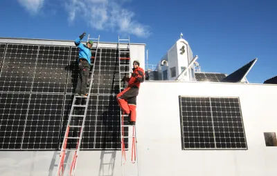 Guus and Johan wiring new solar panels on PEA gagarge