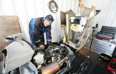 Yann the mechanic working on a ski-doo