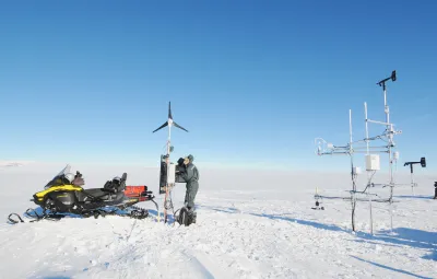 Armin Sigmund sets up a wind turbine to help power a remote sensing station