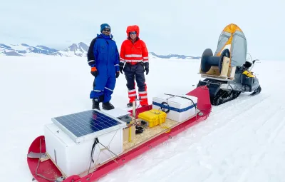 Eric Rignot and Ratnakar Gadi from UC Irvine pose with radar sledge