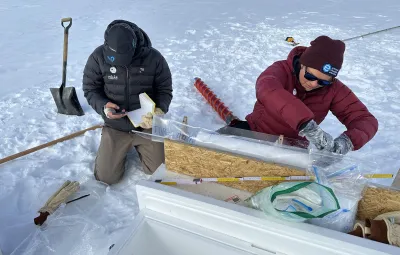 ULB scientist Sarah Wauthy and field guide Sebastian Corret prepare a snow core taken near PEA for the PASPARTOUT project