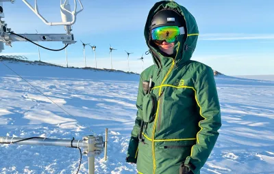 Rainette Engberg poses with a sonic anemometer near the tower at PEA.