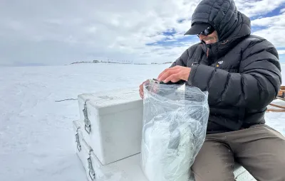 Sebastian Corret storing snow samples for PASPARTOUT project from trench near PEA
