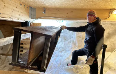 A steel I-beam is slid underneah the staiton's annex