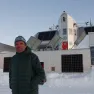 Alain Hubert poses in front of the Princess Elisabeth Antarctica, November 2023